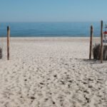 sandy beach entrance with clear blue sky